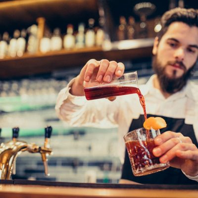 handsome-bartender-making-drinking-and-cocktails-at-a-counter